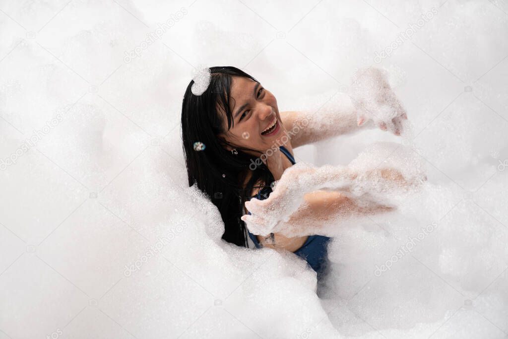 Girl playing in bubble pool with fun and joy