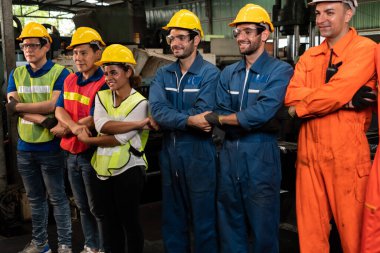 Fabrikadaki takım çalışmasını gösteren becerikli bir işçi bir arada duruyor. .
