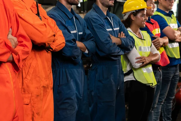 Skillful worker stand together showing teamwork in the factory .