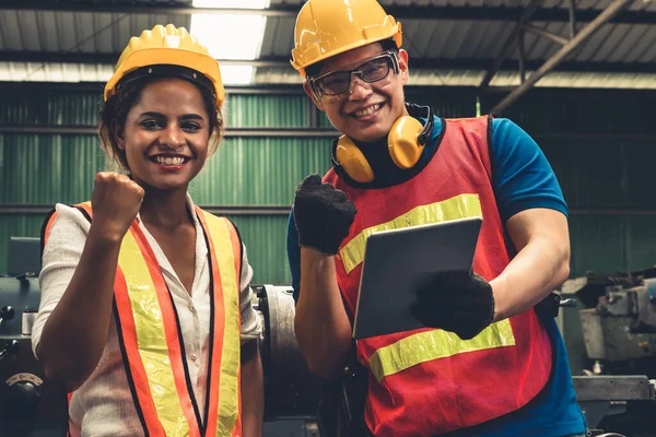 Two skillful factory engineer or worker happy portrait looking at camera