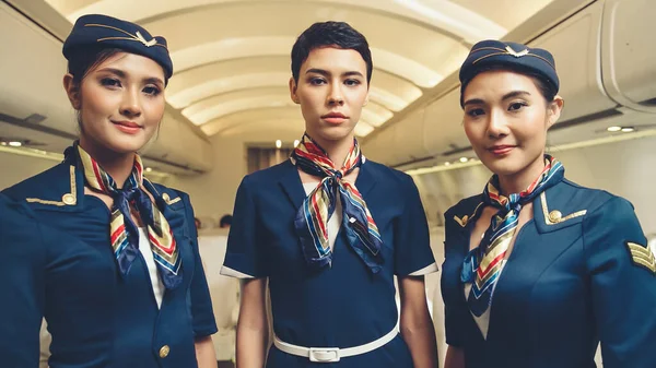 Group of cabin crew or air hostess in airplane — Stock Photo, Image