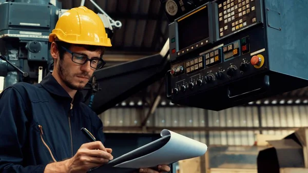 Abile operaio di fabbrica che lavora con appunti per fare procedura di lavoro lista di controllo . — Foto Stock