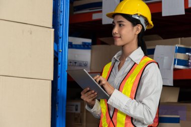 Depoda çalışan kadın bir depo işçisi.