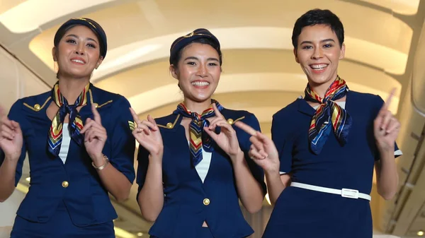 Cabin crew dancing with joy in airplane — Stock Photo, Image