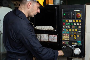 Fabrika mühendisi veya işçisi üretim atölyesinde makine işi yapıyor.