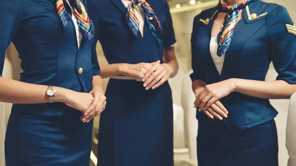 Group of cabin crew or air hostess in airplane — Stock Photo, Image