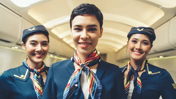 Group of cabin crew or air hostess in airplane — Stock Photo, Image