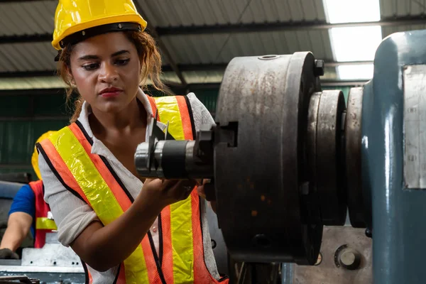 Skillful factory woman worker do machine job in manufacturing workshop