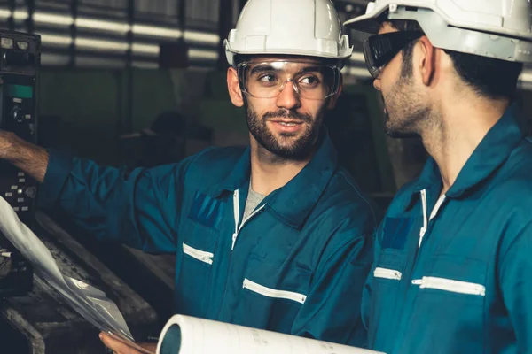 Grupo de trabalhadores de fábrica habilidosos usando equipamentos de máquinas em oficina — Fotografia de Stock