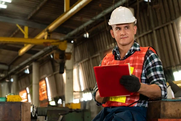 Trabajador de fabricación que trabaja con portapapeles para hacer la lista de verificación del procedimiento de trabajo . — Foto de Stock
