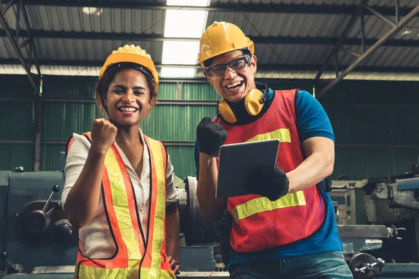 Two skillful factory engineer or worker happy portrait looking at camera