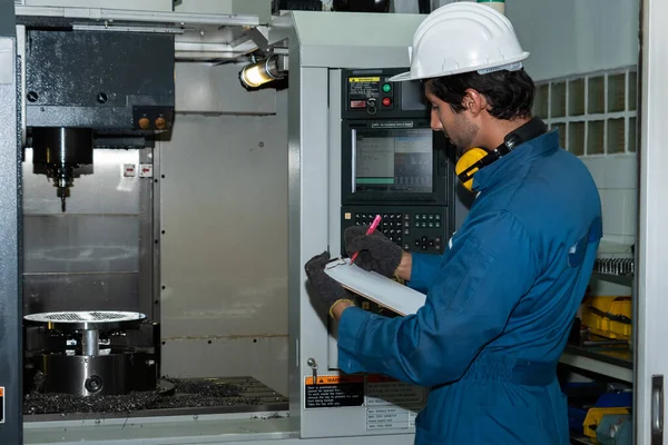 Smart factory worker or engineer do machine job in manufacturing workshop
