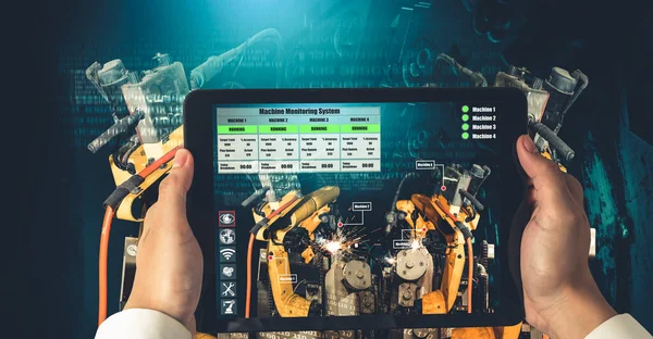 Mühendis, artırılmış gerçeklik endüstrisi teknolojisiyle robotik kolları kontrol ediyor.