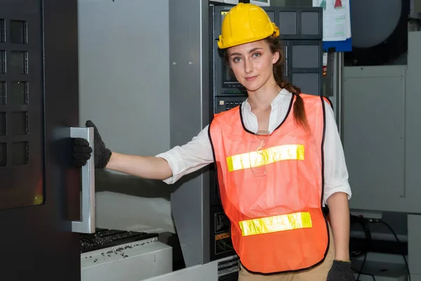 Young woman factory worker close up portrait in manufacturing job factory