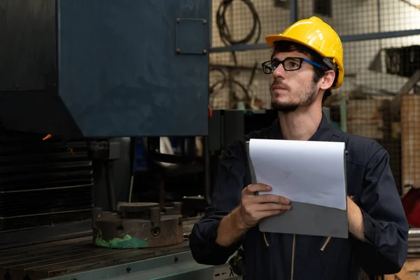 Dovedný tovární dělník pracující se schránkou k provedení kontrolního seznamu procedur . — Stock fotografie