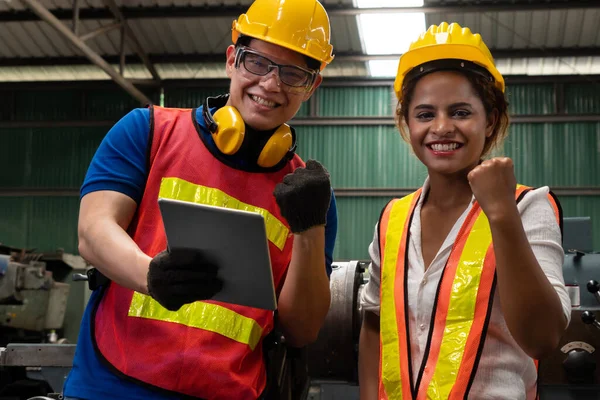 Two skillful factory engineer or worker happy portrait looking at camera