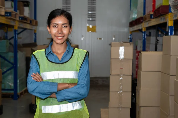 Portrait of young woman warehouse worker smiling in the storehouse