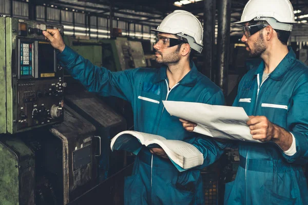 Grupo de trabalhadores de fábrica habilidosos usando equipamentos de máquinas em oficina — Fotografia de Stock