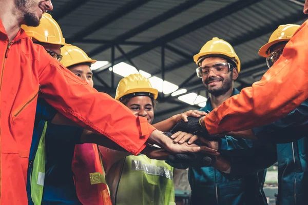 Skillful worker stand together showing teamwork in the factory .