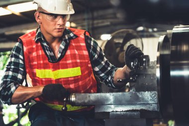 Akıllı fabrika işçisi veya mühendisi bir imalat atölyesinde makine işi yapıyor.