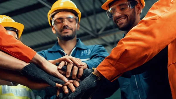 Skillful worker stand together showing teamwork in the factory .