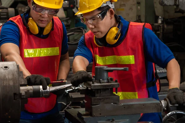 Groupe d'ouvriers habiles d'usine utilisant l'équipement de machine dans l'atelier — Photo