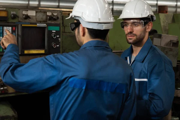 Group of skillful factory workers using machine equipment in workshop — Stock Photo, Image