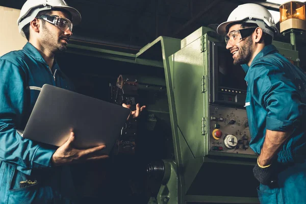 Group of skillful factory workers using machine equipment in workshop — Stock Photo, Image