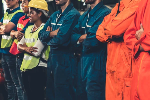 Skillful worker stand together showing teamwork in the factory .