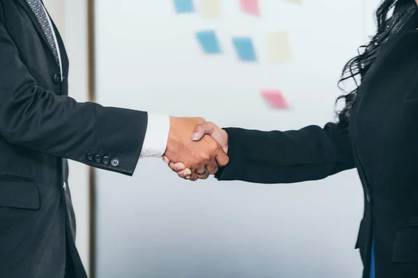 Business people handshake agreement in office.