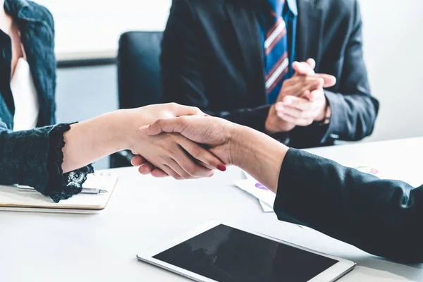 Business people handshake agreement in office.