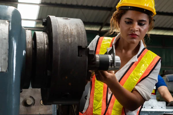 Skillful factory woman worker do machine job in manufacturing workshop