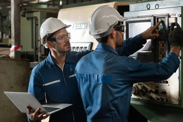 Group of skillful factory workers using machine equipment in workshop — Stock Photo, Image