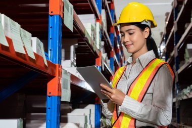 Depoda çalışan kadın bir depo işçisi.