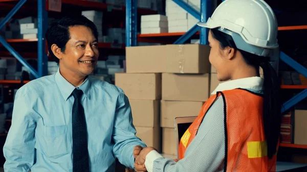 Warehouse manager and worker working in the storehouse