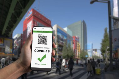 Gezgin COVID 19 aşı durumunu göstermek için aşı pasaport sertifikasına sahip.