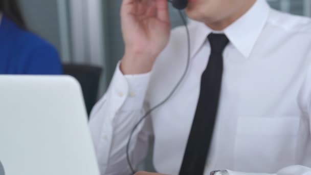 Businessman wearing headset working actively in office — Stock Video