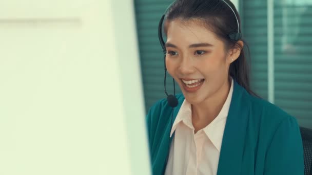 Businesswoman wearing headset working actively in office — Stock Video