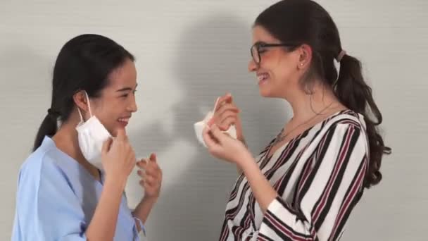 Amigos felizes tirar máscara facial e abraçar uns aos outros de perto juntos — Vídeo de Stock