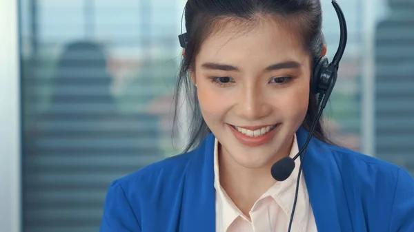 Businesswoman wearing headset working actively in office — Stock Photo, Image