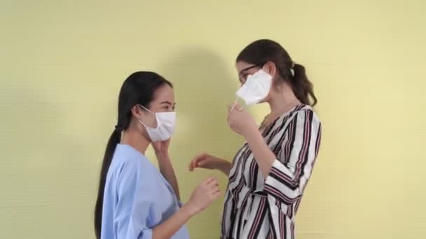 Szczęśliwi przyjaciele zdejmują maskę twarzy i przytulają się blisko siebie. — Wideo stockowe