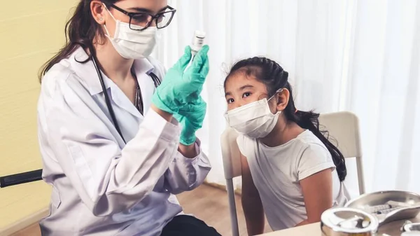 School girl visits skillful doctor at hospital for vaccination