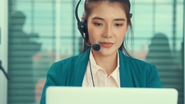 Empresaria con auriculares trabajando activamente en la oficina — Vídeo de stock