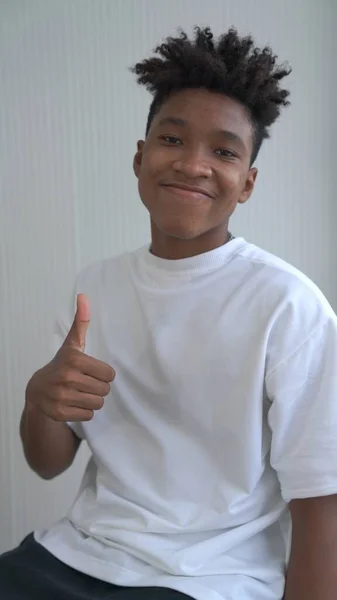 Portrait of young African American teenager merrily pose in studio — Stock Photo, Image