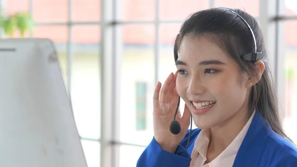 Businesswoman wearing headset working actively in office — Stock Photo, Image