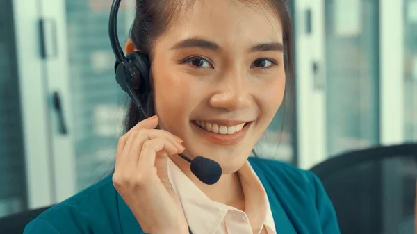 Businesswoman wearing headset working actively in office — Stock Photo, Image