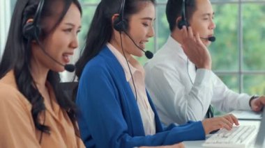 Kulaklık takan iş adamları ofiste aktif olarak çalışıyorlar.