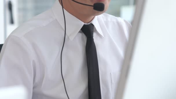 Affärsman med headset som arbetar aktivt på kontoret — Stockvideo