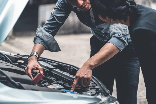 Man helpen vrouw op te lossen de auto probleem. — Stockfoto