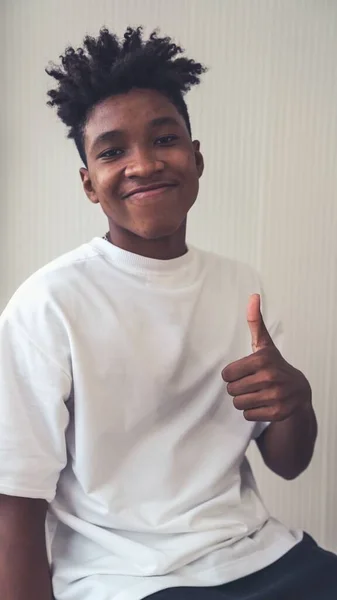 Portrait of young African American teenager merrily pose in studio — Stock Photo, Image